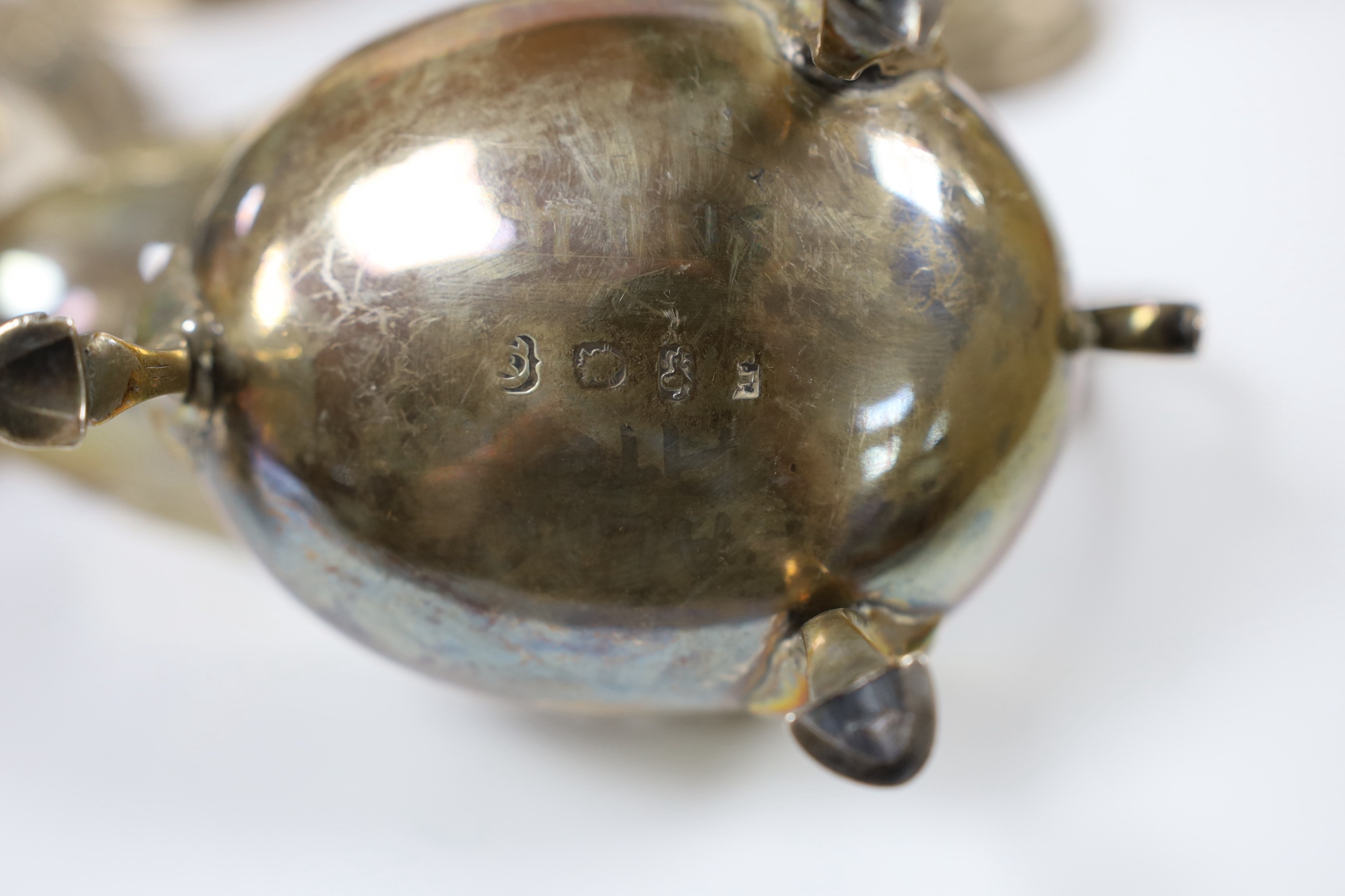 Assorted silver ware including a pair of George V spill vases, a small vase, a two handled trophy cup, sauceboat, mug, caster, stand and toastrack.